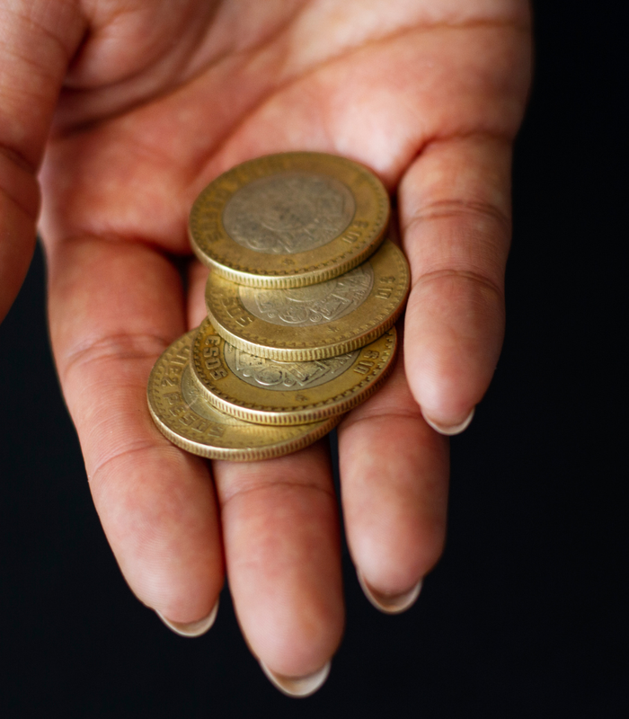 high-angle-hand-holding-coins